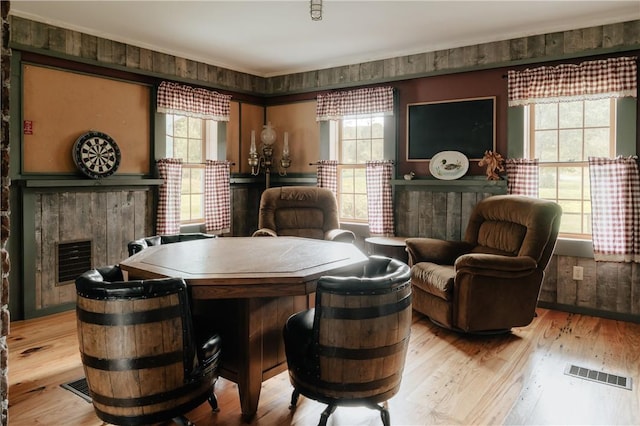 office space with visible vents, wood finished floors, and a fireplace