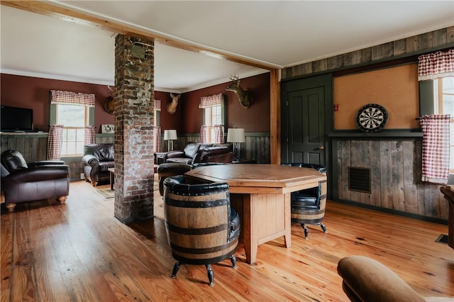 kitchen with decorative columns, open floor plan, visible vents, and wood finished floors