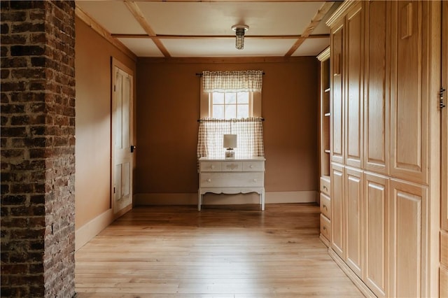 interior space featuring light wood-style flooring and baseboards