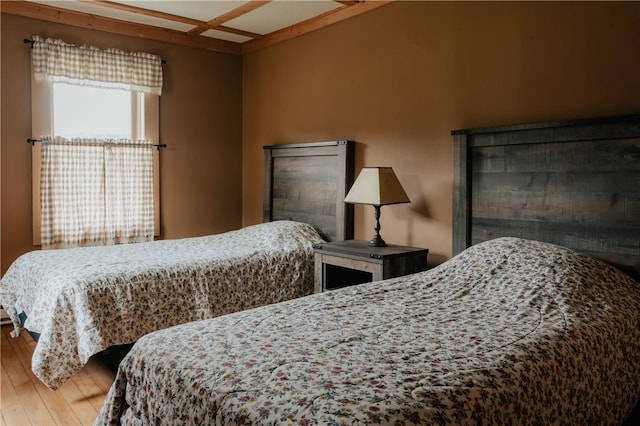 bedroom featuring wood-type flooring and coffered ceiling