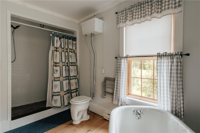 full bathroom featuring a tile shower, a soaking tub, wood finished floors, and baseboard heating
