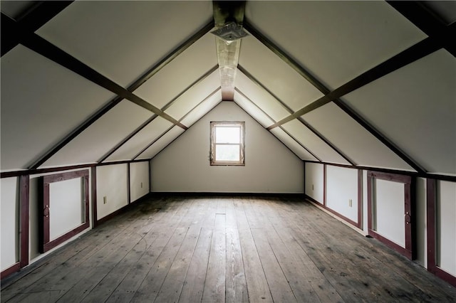 bonus room with vaulted ceiling and hardwood / wood-style flooring