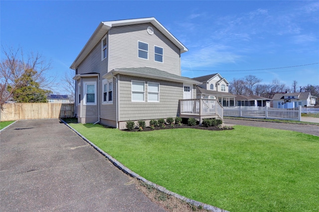 83 Fairview Ave, Islip Terrace, NY 11752 - view of front facade featuring fence and a front lawn