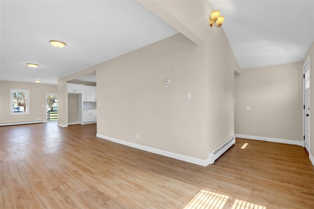 83 Fairview Ave, Islip Terrace, NY 11752 - unfurnished living room with a baseboard radiator, a baseboard heating unit, baseboards, and light wood-type flooring