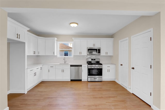83 Fairview Ave, Islip Terrace, NY 11752 - kitchen with light countertops, a sink, white cabinetry, and appliances with stainless steel finishes