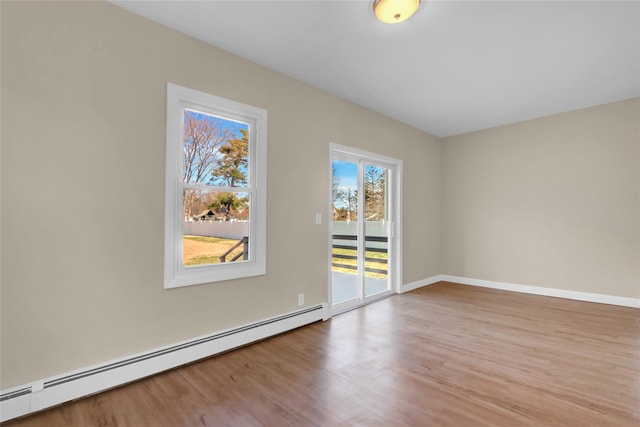 83 Fairview Ave, Islip Terrace, NY 11752 - unfurnished room with baseboard heating, wood finished floors, and baseboards