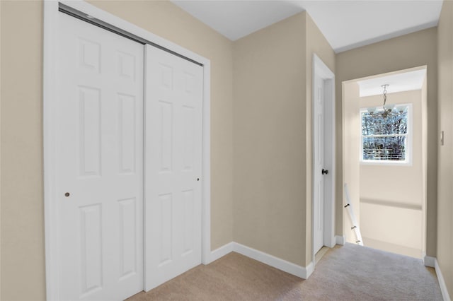 83 Fairview Ave, Islip Terrace, NY 11752 - unfurnished bedroom with a chandelier, a closet, baseboards, and light colored carpet