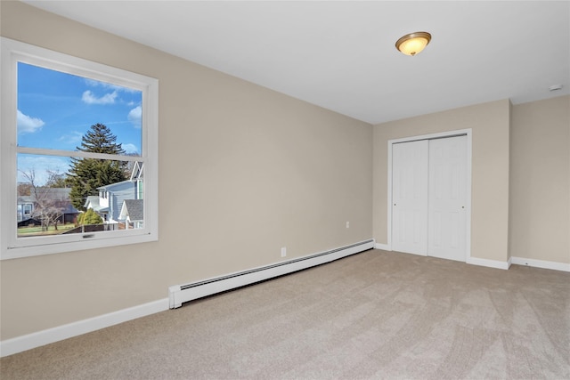 83 Fairview Ave, Islip Terrace, NY 11752 - unfurnished bedroom with light carpet, a baseboard radiator, baseboards, and a closet