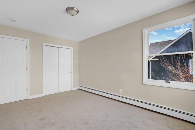 83 Fairview Ave, Islip Terrace, NY 11752 - unfurnished bedroom with baseboard heating, a closet, baseboards, and carpet floors