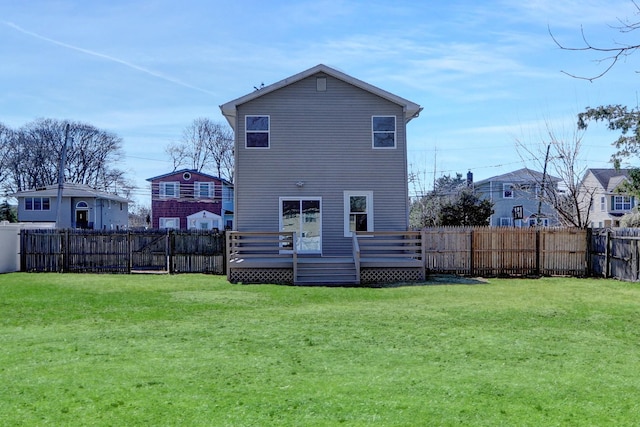 83 Fairview Ave, Islip Terrace, NY 11752 - rear view of house with a yard, a deck, and a fenced backyard