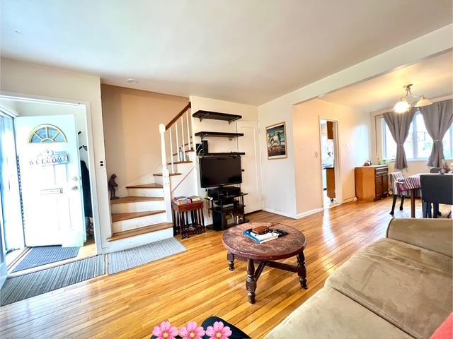 69-40 218th St Duplex, Unit Duplex, Oakland Gardens, NY 11364 - living area featuring stairway, light wood-style flooring, and baseboards