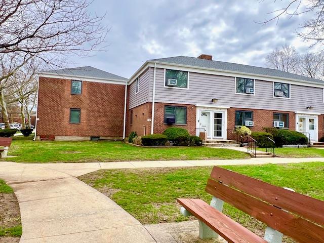69-40 218th St Duplex, Unit Duplex, Oakland Gardens, NY 11364 - view of front of home featuring brick siding, a chimney, a front lawn, and entry steps