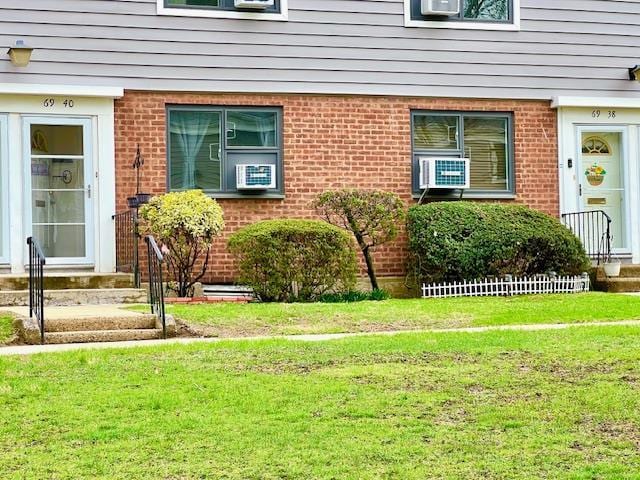 69-40 218th St Duplex, Unit Duplex, Oakland Gardens, NY 11364 - property entrance with a yard, brick siding, and cooling unit