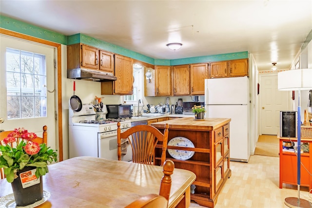 20 Bowers Dr, Hurleyville, NY 12747 - kitchen featuring white appliances, under cabinet range hood, butcher block counters, and plenty of natural light