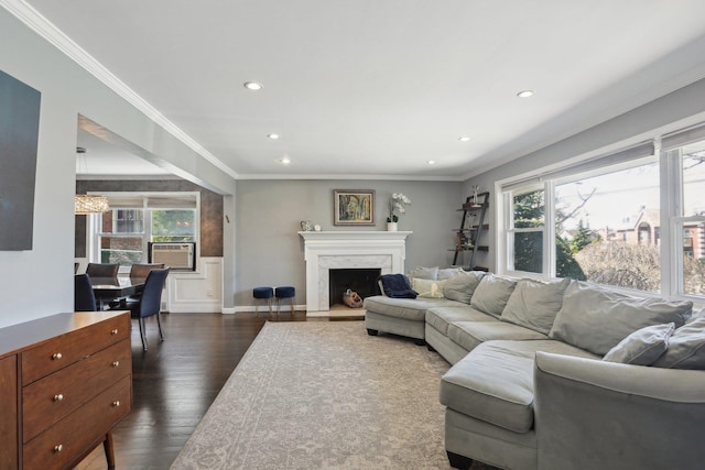 living area with a premium fireplace, recessed lighting, dark wood-type flooring, and ornamental molding