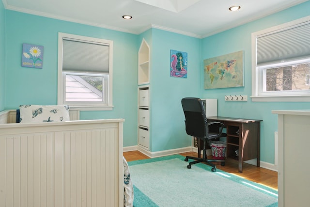 office space featuring plenty of natural light, wood finished floors, recessed lighting, and crown molding
