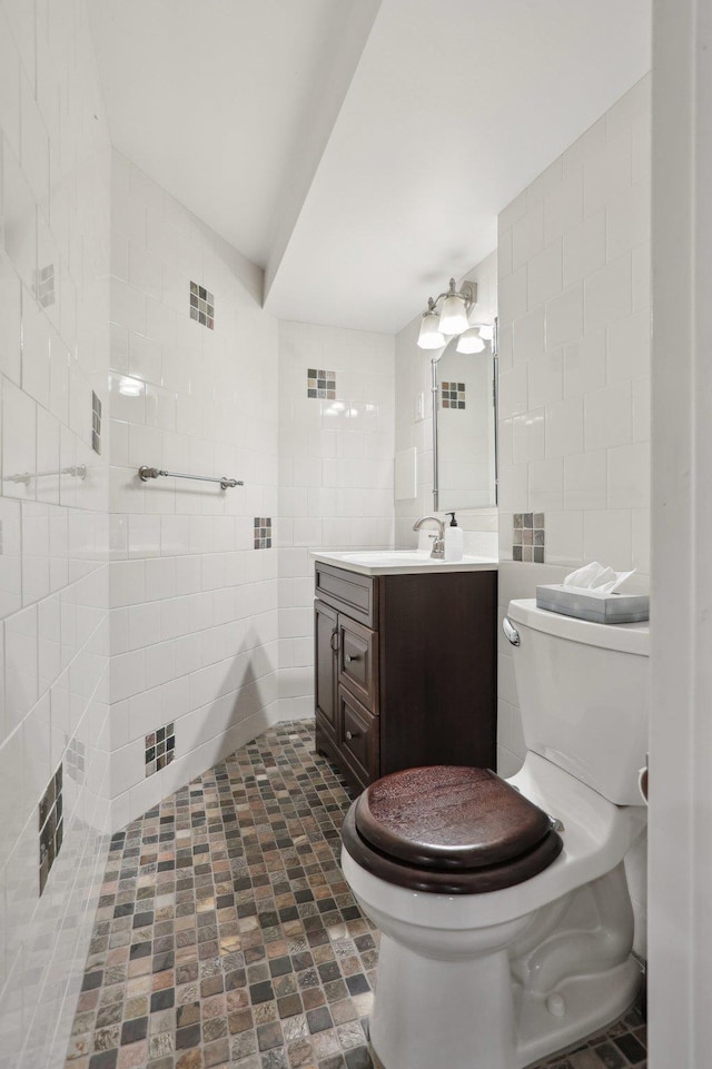 bathroom featuring tile walls, visible vents, toilet, and vanity
