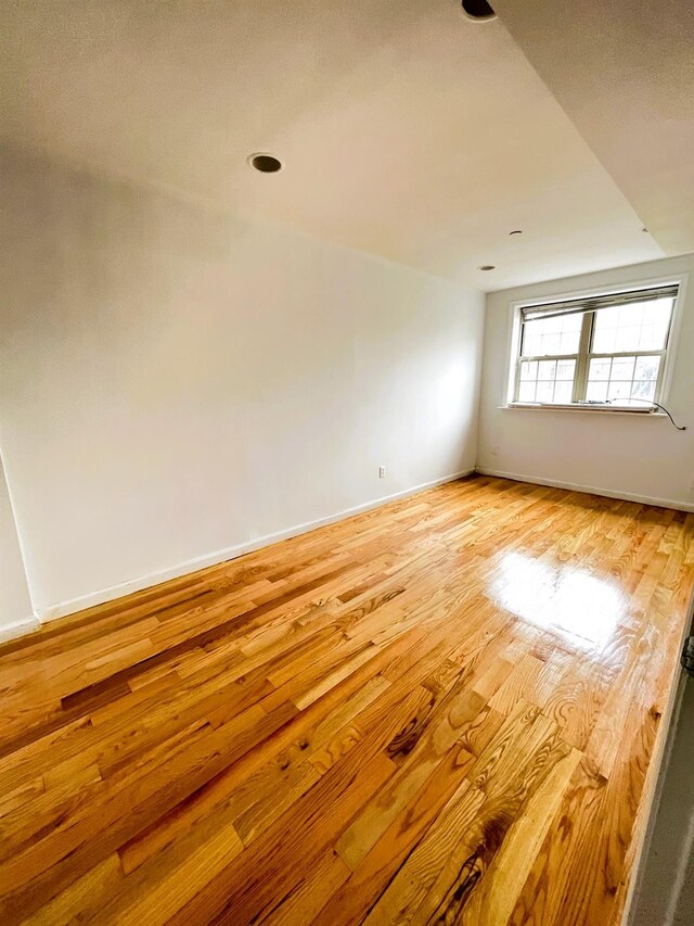 104-27 38th Ave Unit 1B, Corona, NY 11368 - empty room with light wood-type flooring and baseboards