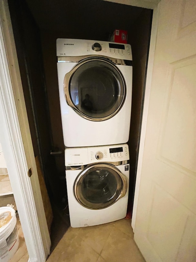 104-27 38th Ave Unit 1B, Corona, NY 11368 - laundry room with light tile patterned flooring, laundry area, and stacked washer and clothes dryer