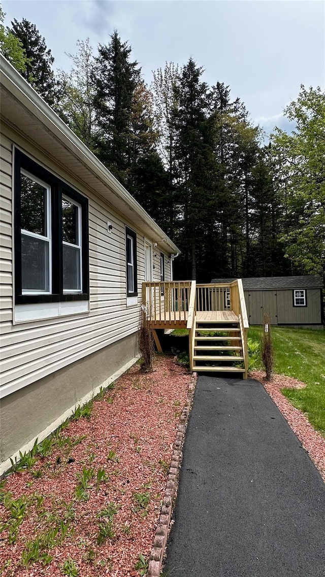 734 Cooley Rd, Parksville, NY 12768 - view of property exterior featuring a deck, an outdoor structure, and view of scattered trees
