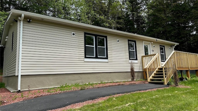 734 Cooley Rd, Parksville, NY 12768 - view of front of house with a wooden deck, view of wooded area, and stairs