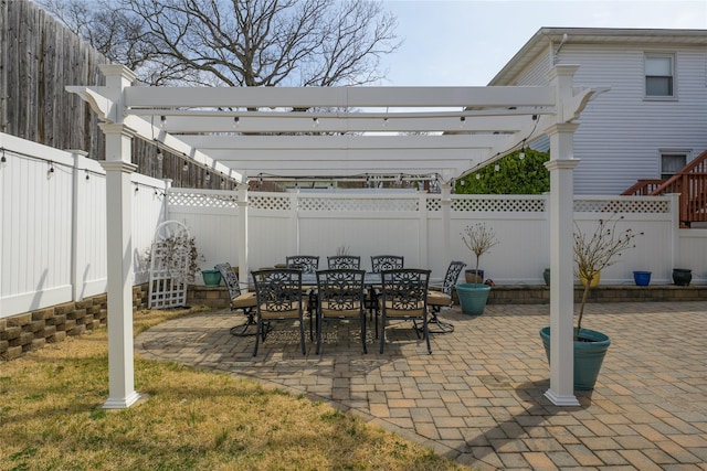 view of patio featuring a pergola, a fenced backyard, and outdoor dining space