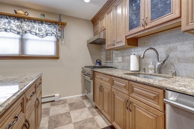 kitchen featuring a baseboard heating unit, backsplash, under cabinet range hood, stainless steel appliances, and a sink
