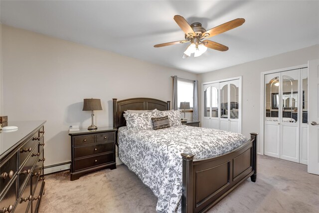 bedroom with light carpet, a baseboard heating unit, a ceiling fan, and multiple closets