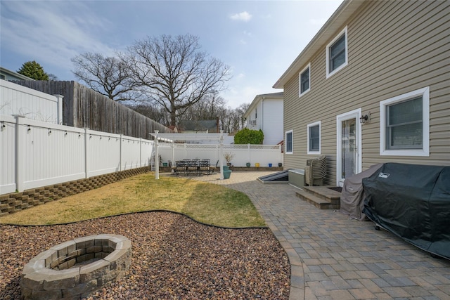 view of yard with a patio, a fire pit, and a fenced backyard