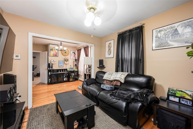 1290 Edison Ave, Bronx, NY 10461 - living room with wood finished floors and ceiling fan with notable chandelier