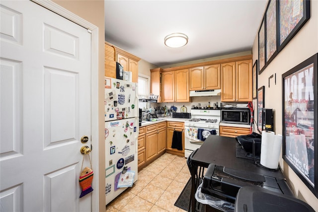 1290 Edison Ave, Bronx, NY 10461 - kitchen with light tile patterned floors, white appliances, under cabinet range hood, light countertops, and light brown cabinets