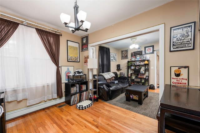 1290 Edison Ave, Bronx, NY 10461 - living area featuring a chandelier, a baseboard heating unit, and hardwood / wood-style floors