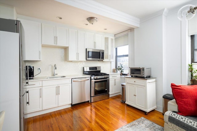 710 Riverside Dr Unit 6B, New York Manhattan, NY 10031 - kitchen with a toaster, a sink, white cabinets, and stainless steel appliances