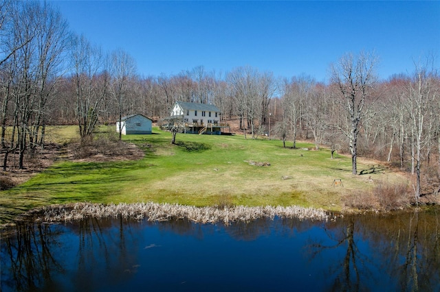 exterior space featuring a water view and a wooded view
