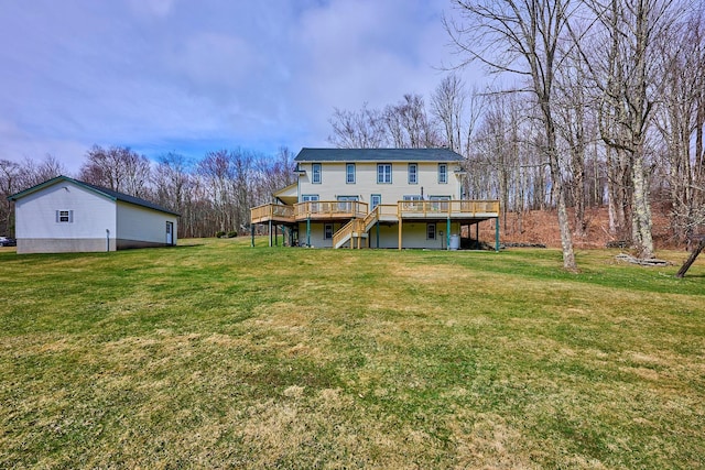 back of house featuring a yard, a deck, and stairway