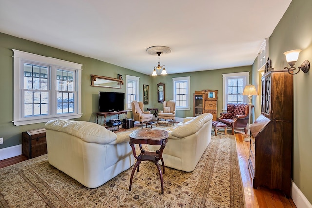 living room with baseboards and wood finished floors
