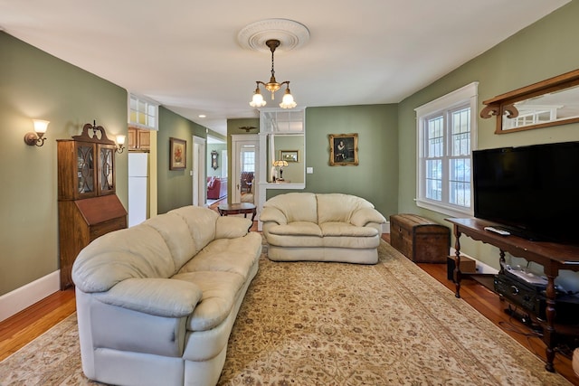 living area featuring baseboards and wood finished floors