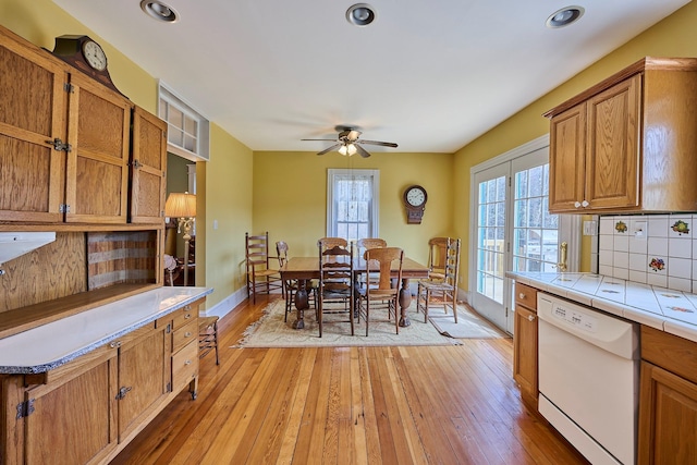 dining room with recessed lighting, a ceiling fan, light wood-style flooring, and baseboards