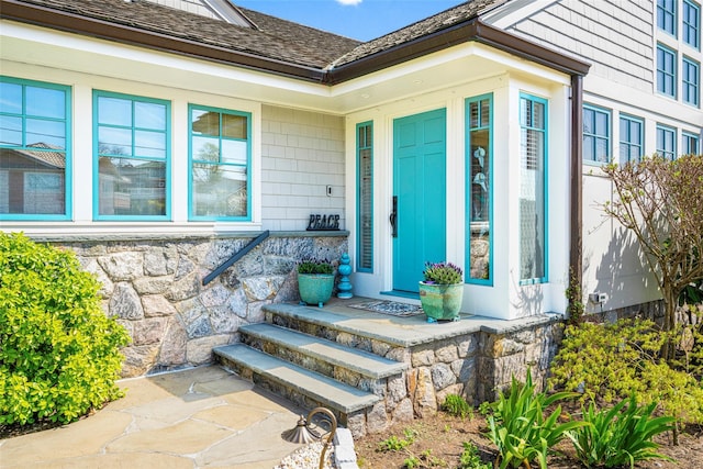 property entrance with covered porch and stone siding
