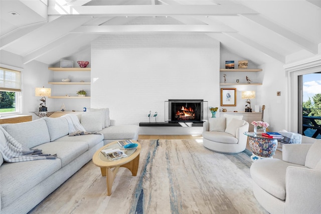 living area featuring high vaulted ceiling, wood finished floors, a fireplace, and beamed ceiling