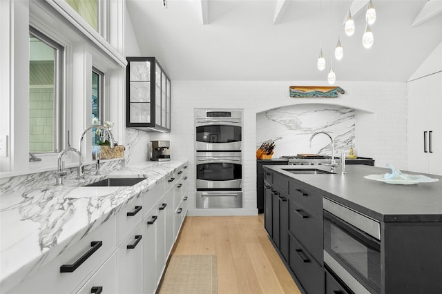kitchen featuring stainless steel double oven, a sink, built in microwave, and a warming drawer