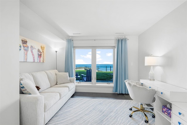 office space featuring visible vents, built in study area, and a water view