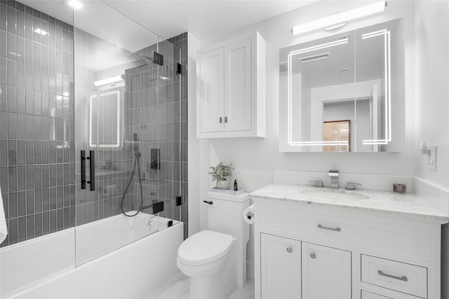 bathroom featuring shower / bath combination with glass door, toilet, visible vents, and vanity