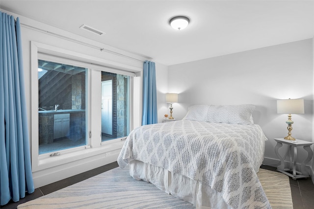 bedroom featuring baseboards and visible vents