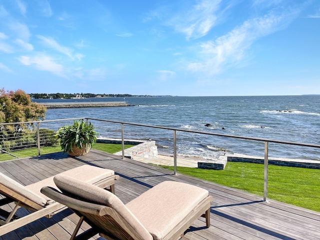 wooden deck featuring a lawn and a water view