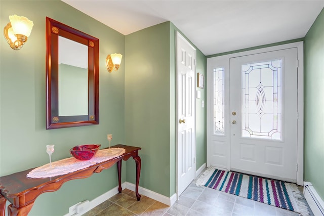 foyer with tile patterned floors, baseboard heating, and baseboards