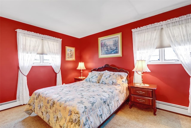 bedroom with carpet flooring, a baseboard radiator, and baseboards