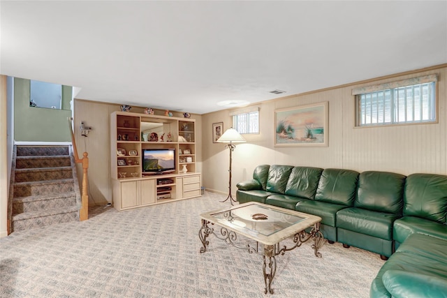 living room with stairs, carpet flooring, visible vents, and a healthy amount of sunlight