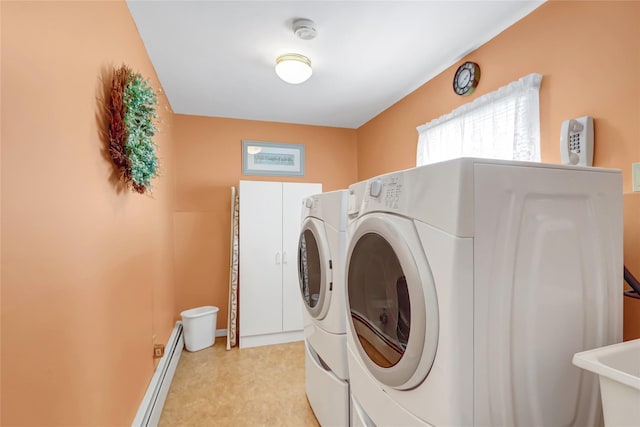 laundry area featuring laundry area, separate washer and dryer, a baseboard heating unit, and a sink