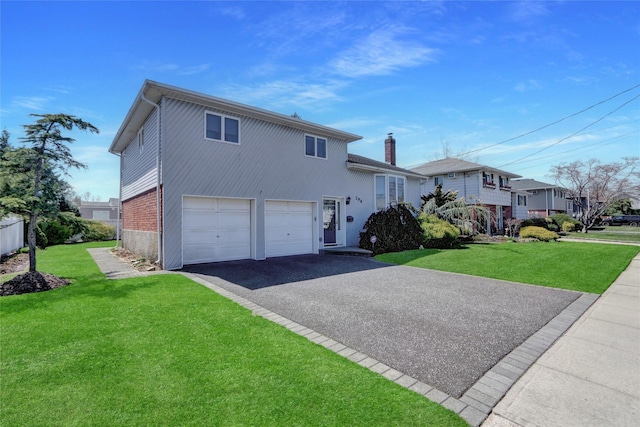 split level home with driveway, a chimney, an attached garage, and a front lawn